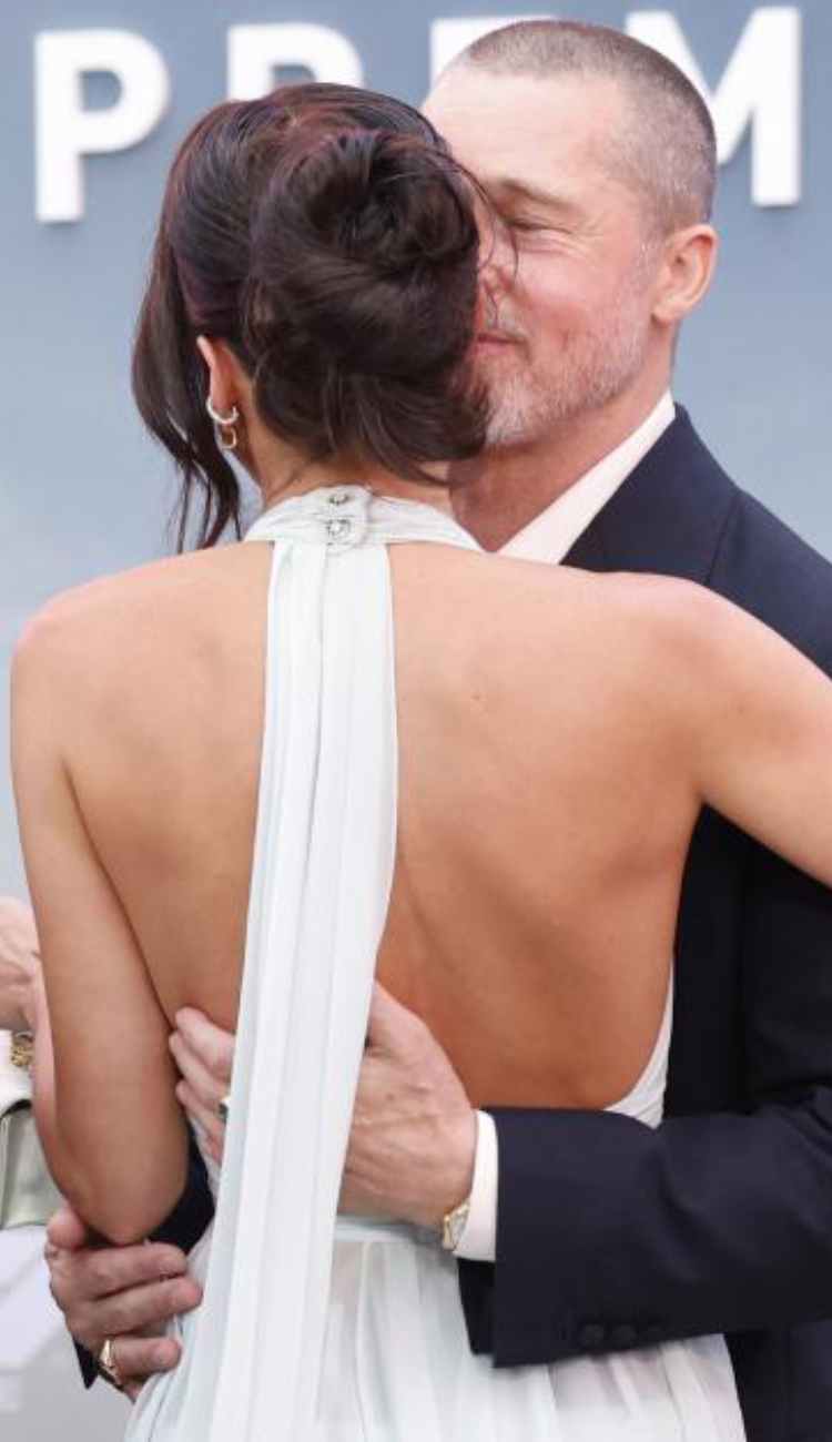 Brad Pitt dodges a kiss from girlfriend Ines de Ramon at the F1 premiere