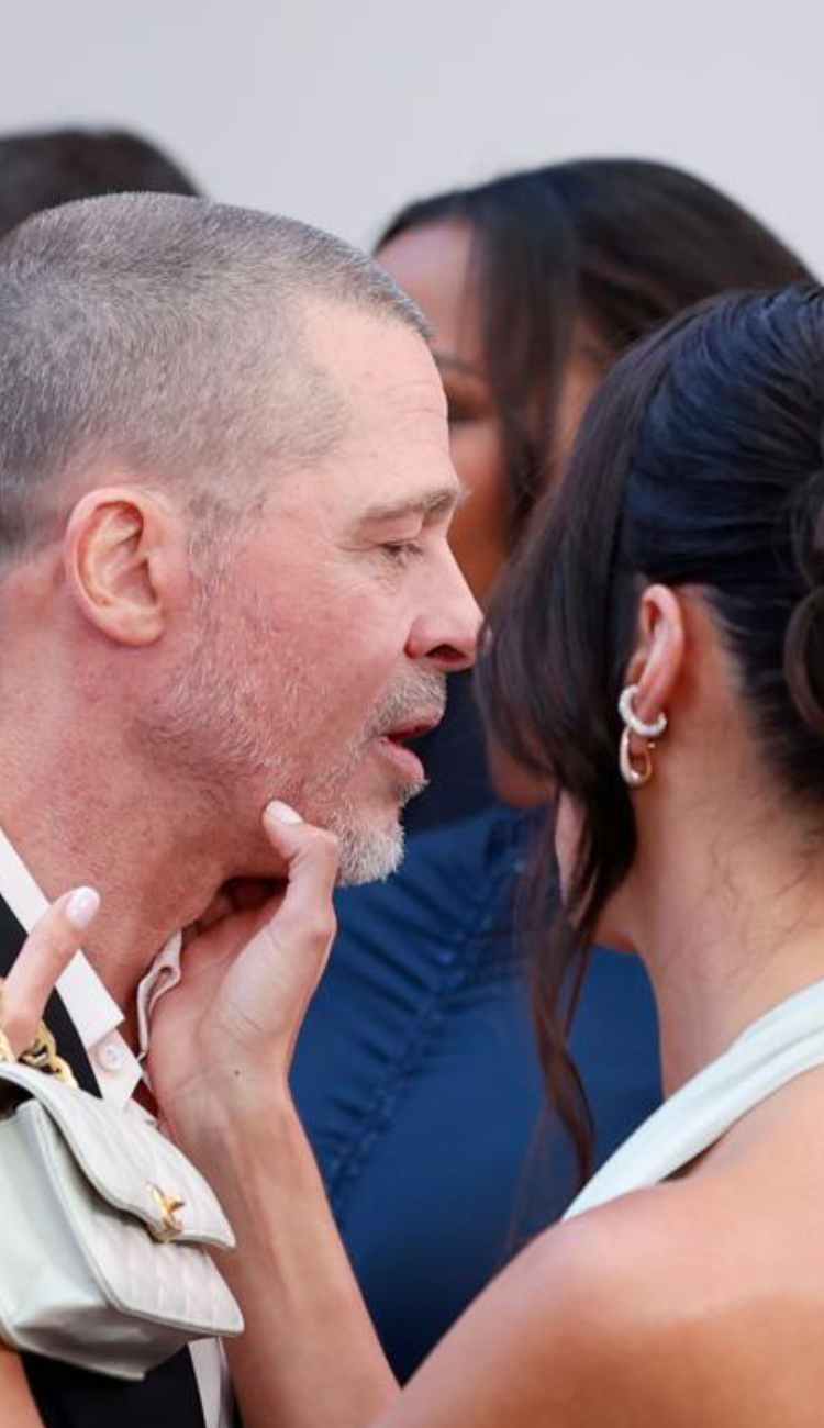Brad Pitt dodges a kiss from girlfriend Ines de Ramon at the F1 premiere