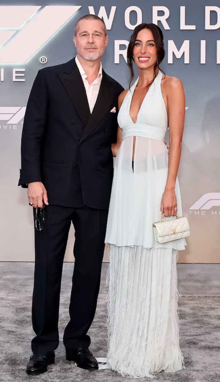 Brad Pitt dodges a kiss from girlfriend Ines de Ramon at the F1 premiere