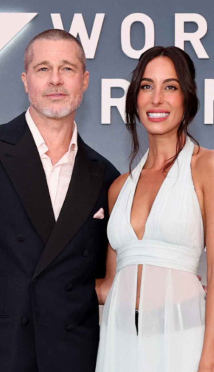 Brad Pitt dodges a kiss from girlfriend Ines de Ramon at the F1 premiere