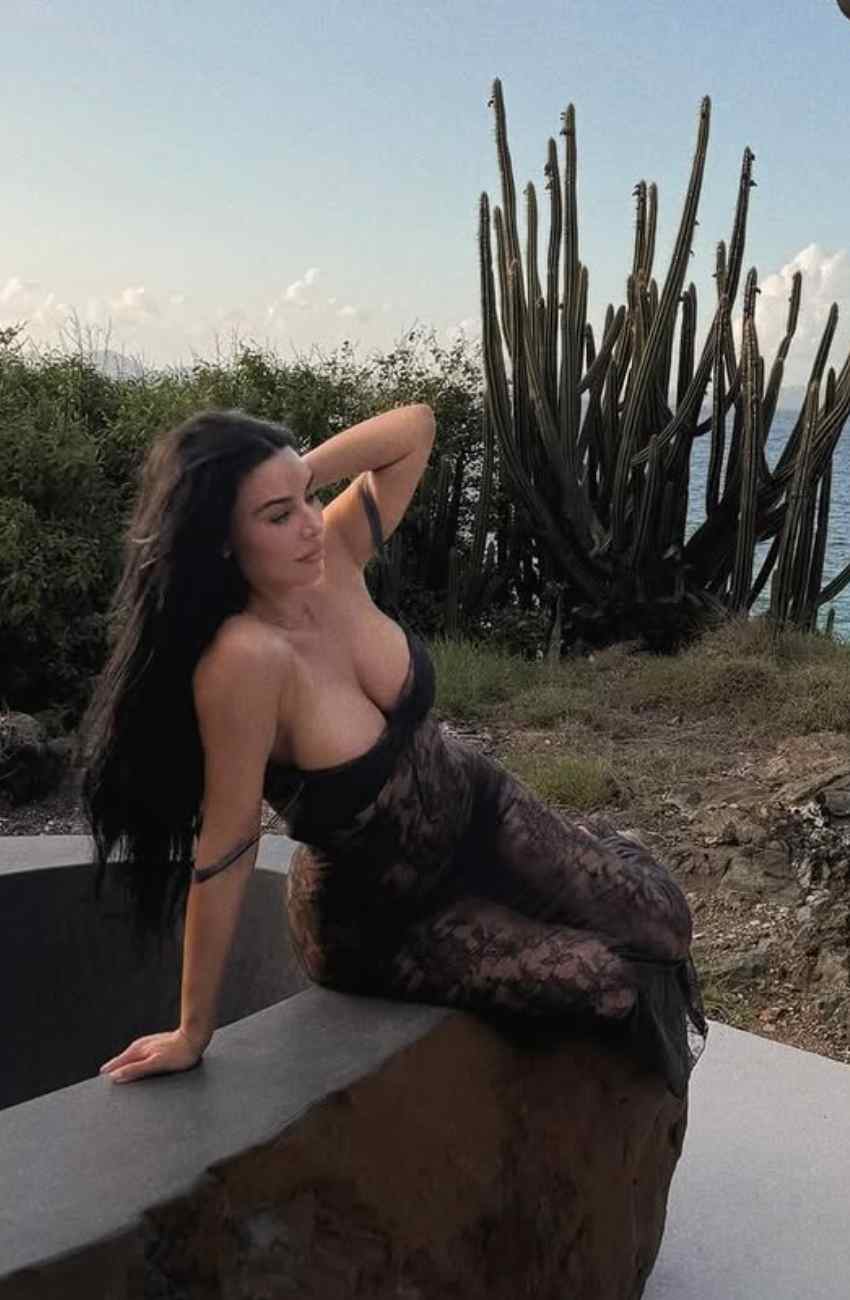 Kim Kardashian Wears Vintage-Inspired Sheer Lace Dress by the Sea