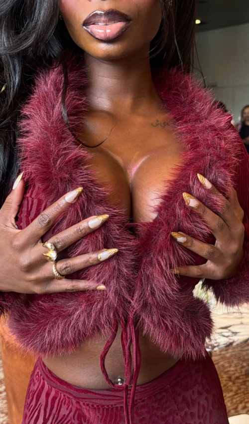 Love Island Star Ndidi Nwosu Stuns in Crimson Fur and Sheer Lace at SI Swimsuit Event